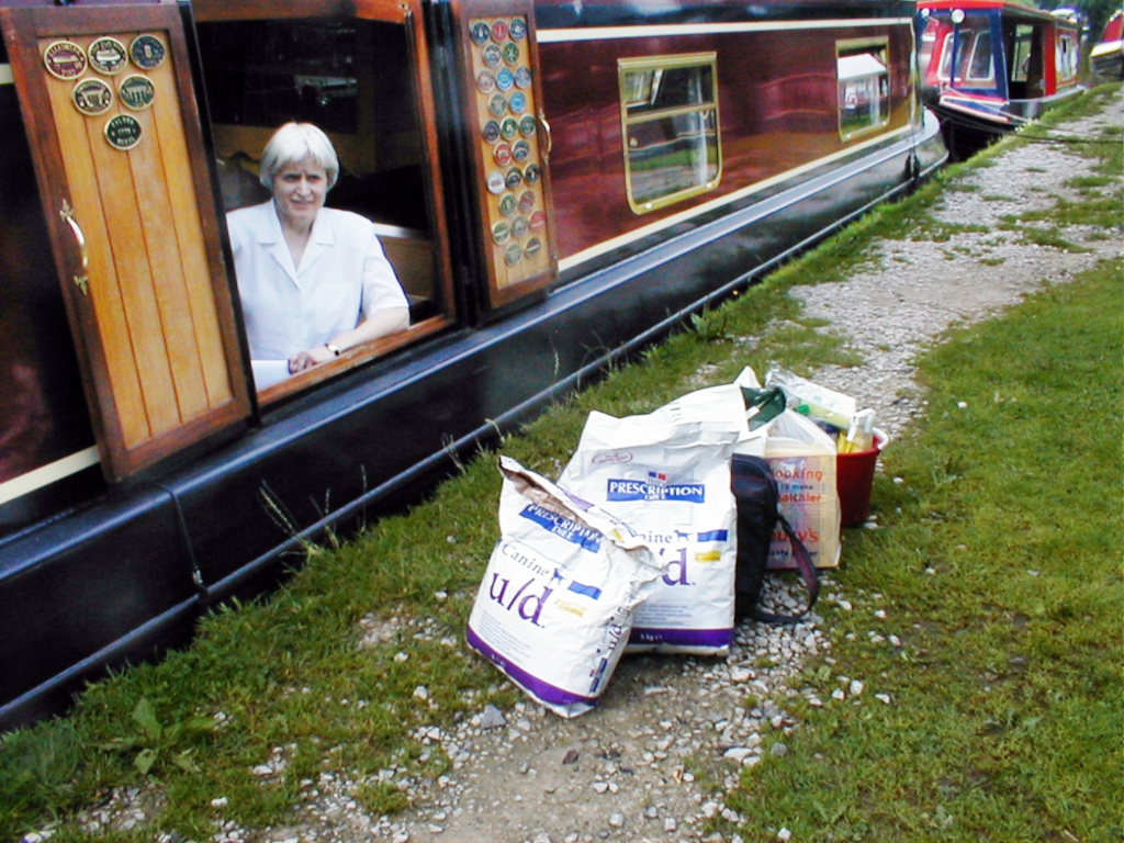 woman looking out of a side hatch on narrowboat Stolen Time