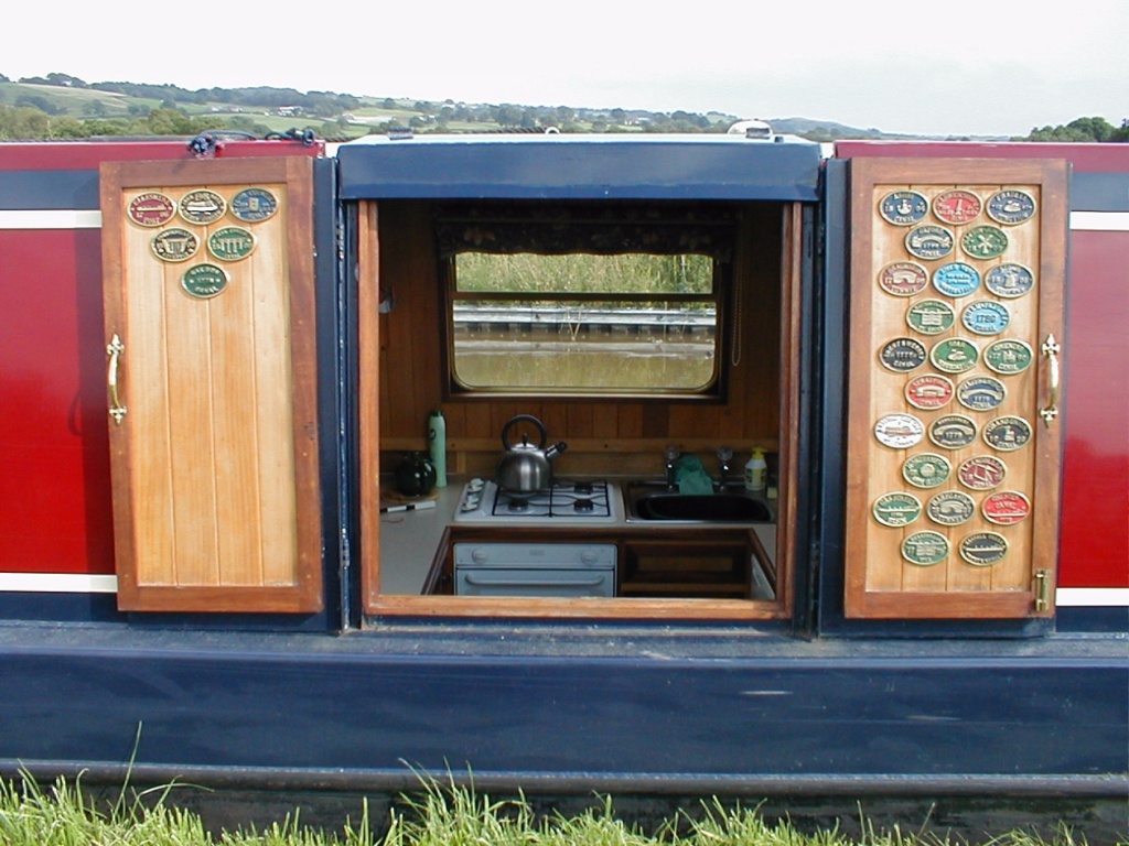 Side hatch adorned with many brass plaques