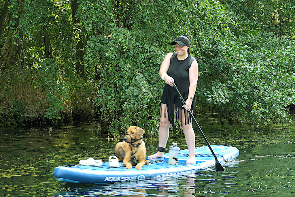 Girl on paddleboard with dog